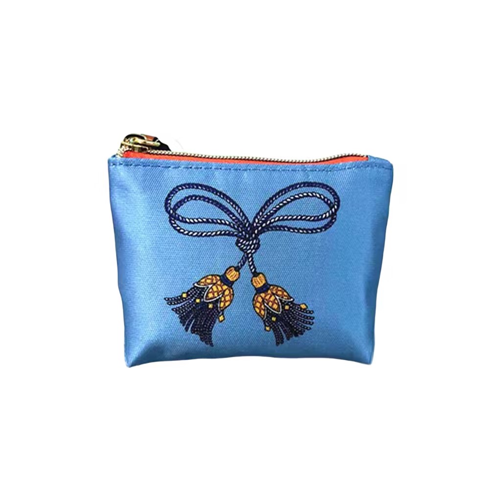 Looking for a light blue cosmetic bag with an elegant bow detail?