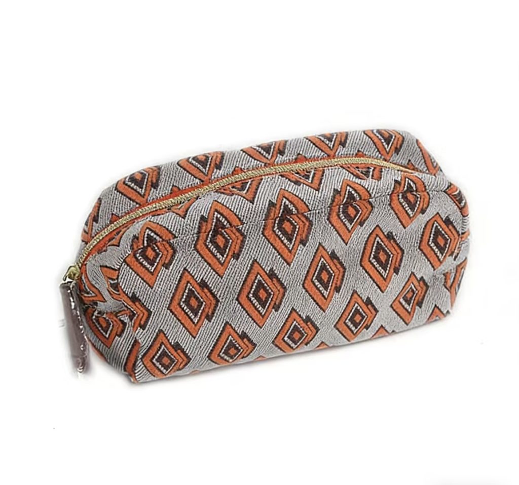 Could a vintage-inspired geometric cosmetic bag like this Estée Lauder design elevate your brand's gift collection?