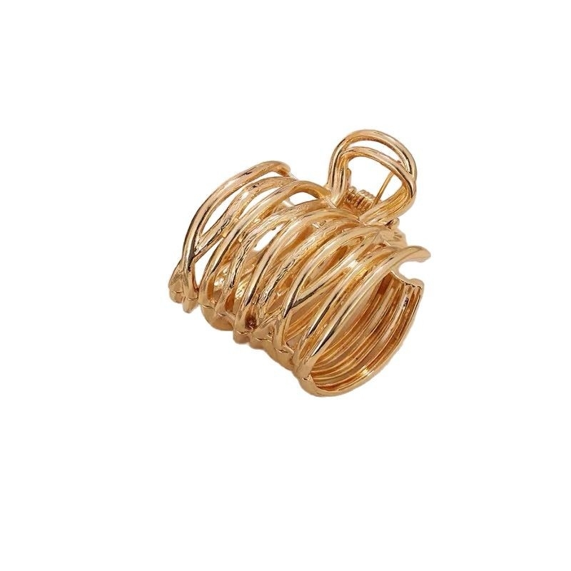 Need a gold metal claw clip with spiral hollow design for your accessory collection?